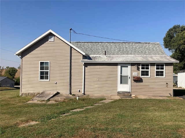 rear view of property with a yard