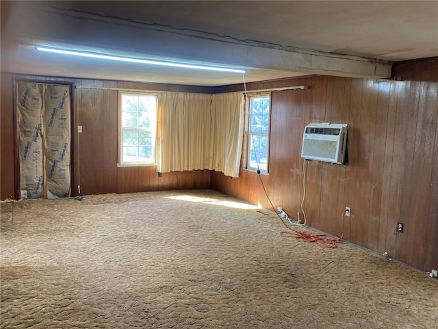 carpeted empty room with wood walls and a wall mounted AC