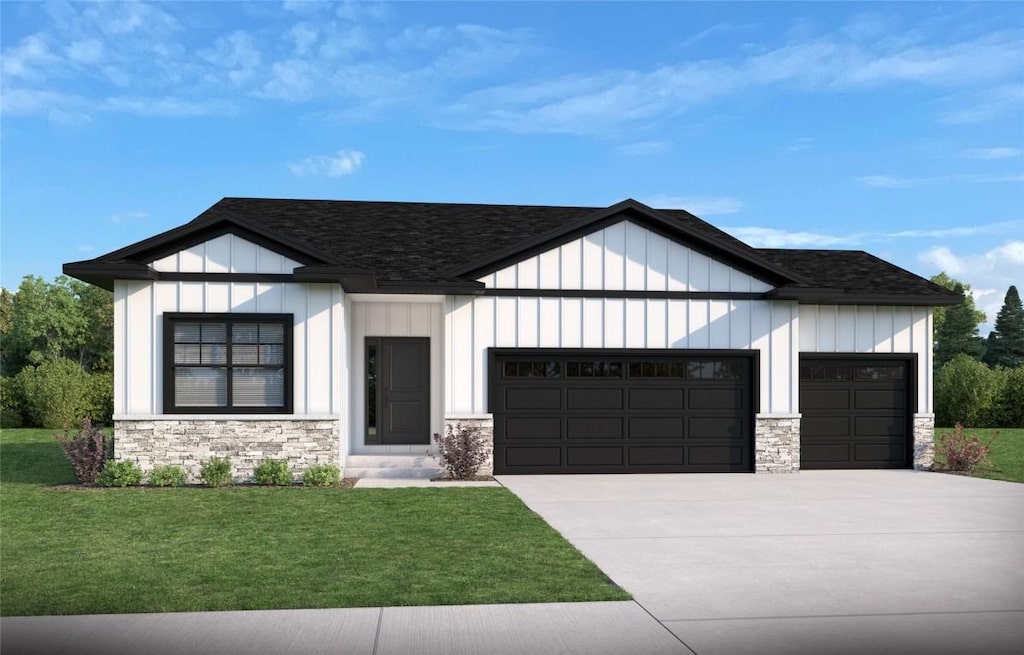 view of front of home with a front lawn and a garage