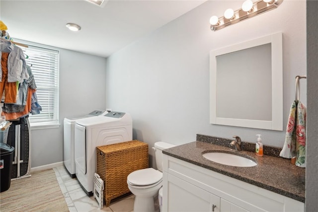 bathroom with vanity, toilet, and washer and clothes dryer