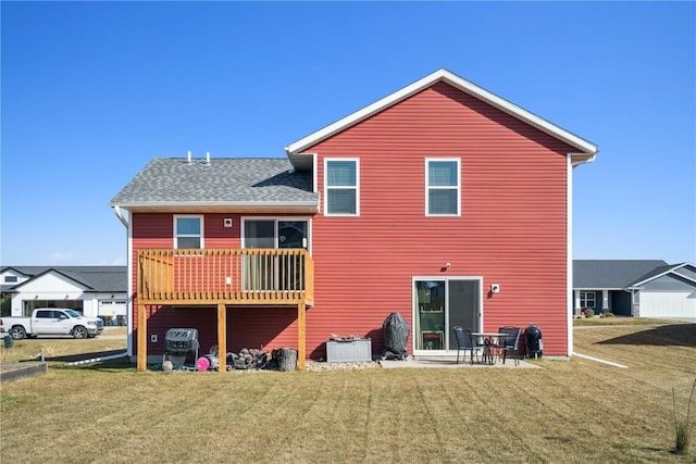 rear view of house featuring a patio and a lawn