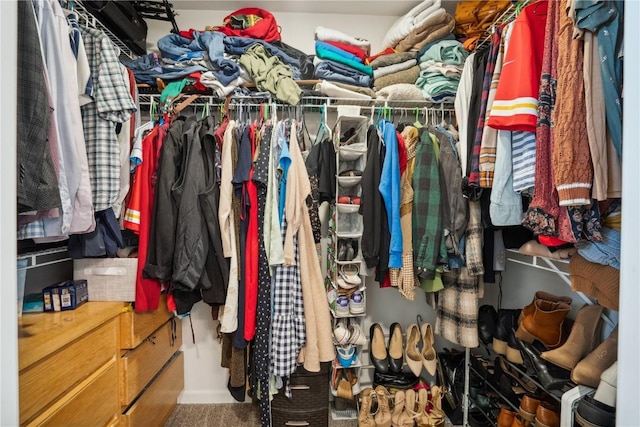 walk in closet with carpet