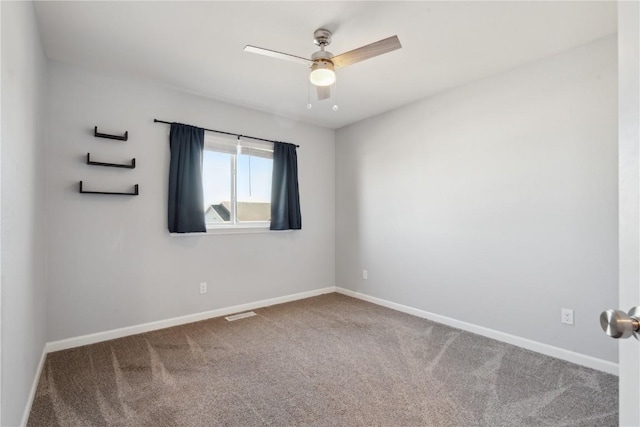 spare room with ceiling fan and carpet