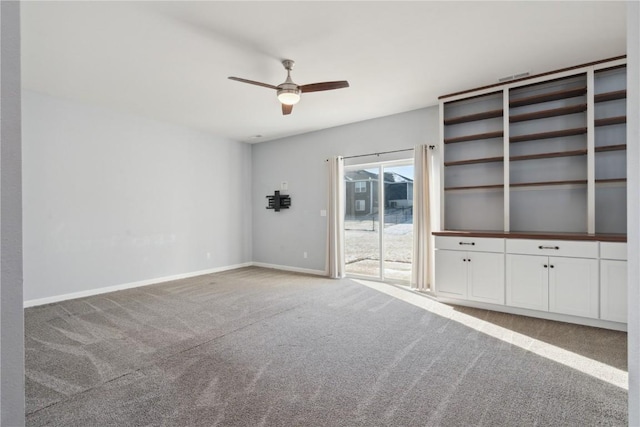 unfurnished living room featuring ceiling fan and carpet