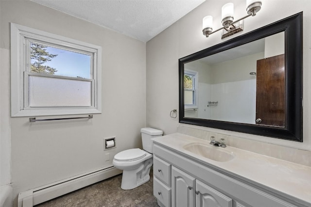 bathroom featuring a textured ceiling, baseboard heating, vanity, and toilet