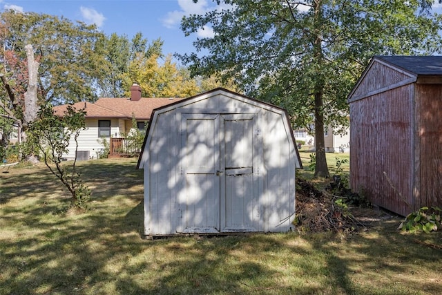 view of outbuilding with a yard