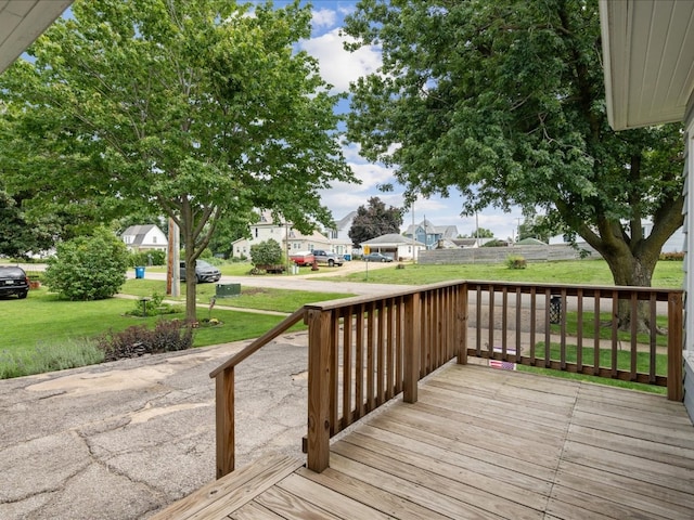 wooden terrace featuring a yard