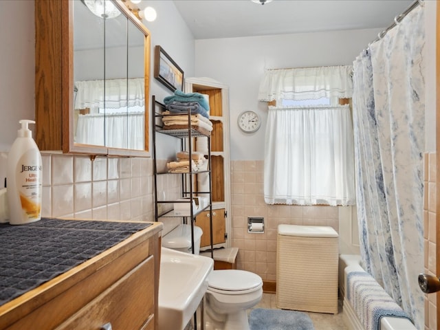 full bathroom with vanity, toilet, tile walls, tile patterned flooring, and shower / tub combo with curtain