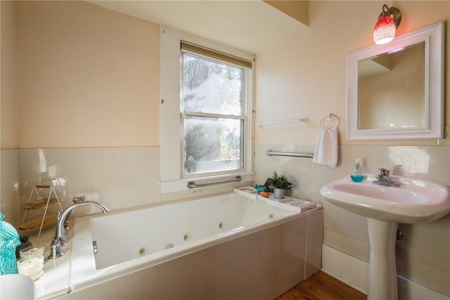 bathroom featuring hardwood / wood-style floors, a bathing tub, and sink