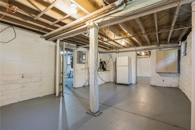 basement featuring white fridge