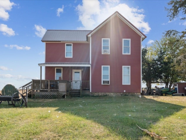 rear view of property featuring a lawn