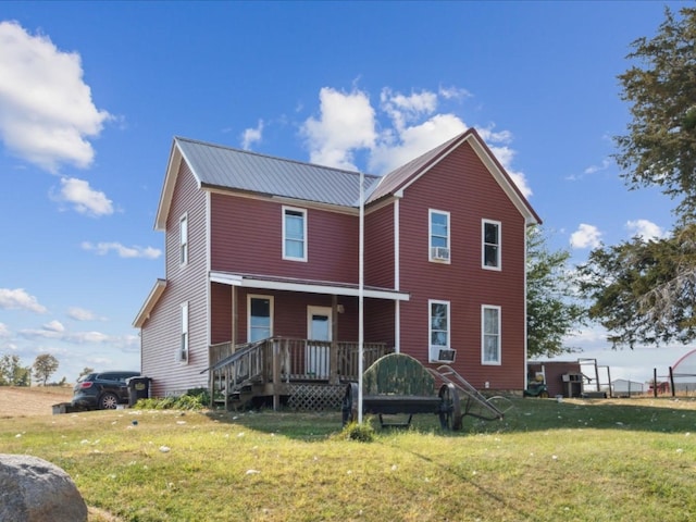 view of front of property with cooling unit and a front lawn