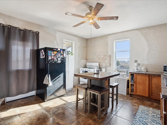 dining area featuring ceiling fan, a textured ceiling, and cooling unit