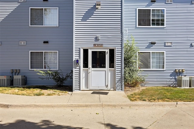 doorway to property featuring central AC unit