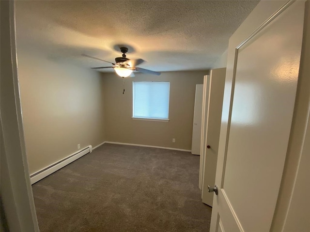 empty room with dark colored carpet, ceiling fan, a baseboard heating unit, and a textured ceiling