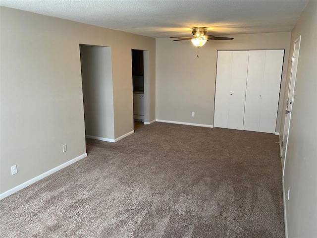 unfurnished bedroom featuring ceiling fan, carpet floors, and a textured ceiling