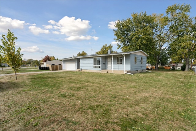 view of front facade featuring a front yard and a garage