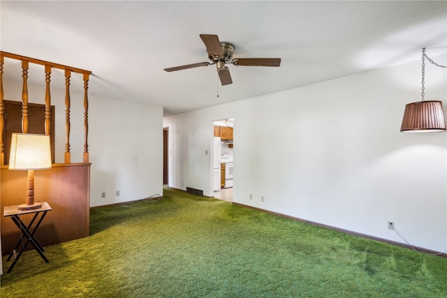 unfurnished living room with ceiling fan and carpet flooring