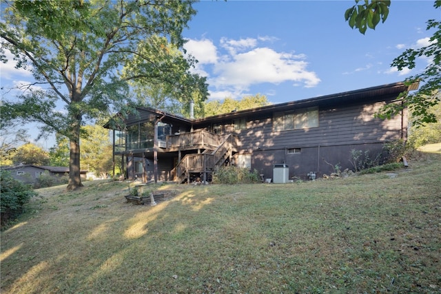 back of property featuring a yard and a sunroom