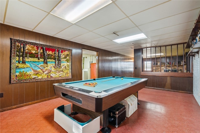 rec room featuring a drop ceiling, billiards, and wooden walls