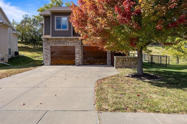 obstructed view of property featuring a garage and a front lawn