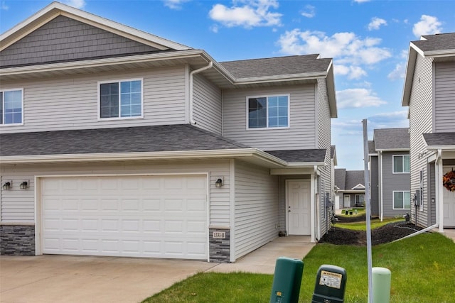 view of front of property featuring a garage and a front yard