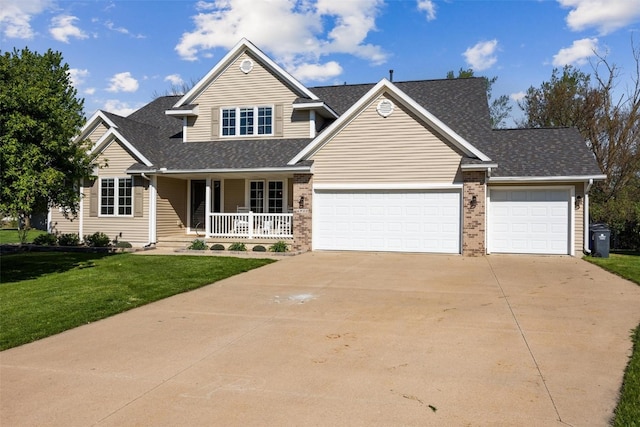 view of front of home with a front lawn, covered porch, and a garage