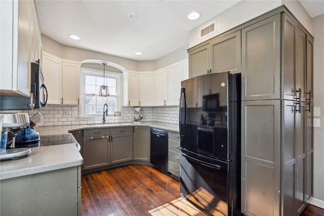 kitchen with black appliances, gray cabinets, dark hardwood / wood-style floors, and hanging light fixtures