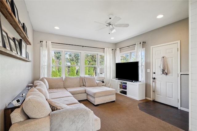 carpeted living room with ceiling fan