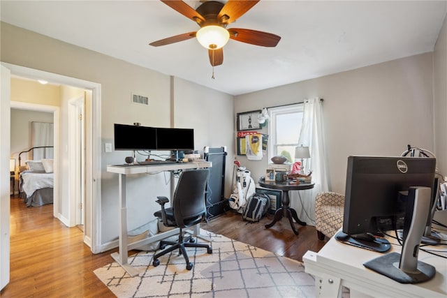 home office with ceiling fan and hardwood / wood-style floors