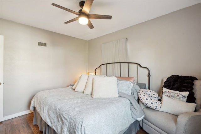 bedroom featuring ceiling fan and dark hardwood / wood-style floors