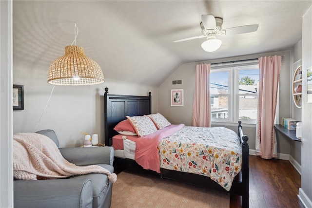 bedroom featuring dark hardwood / wood-style floors, vaulted ceiling, and ceiling fan