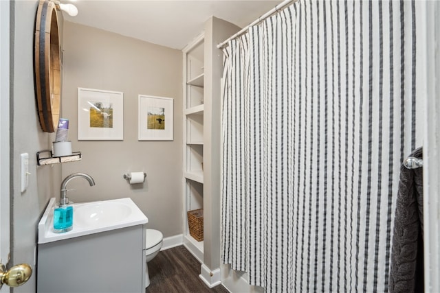 bathroom featuring vanity, hardwood / wood-style floors, curtained shower, and toilet