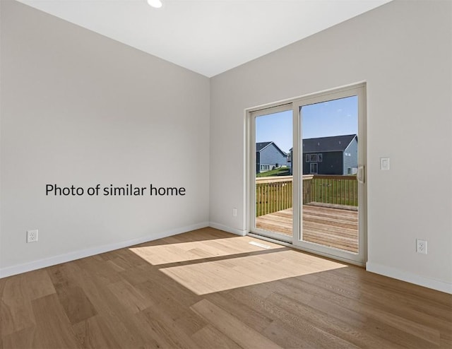 empty room featuring baseboards and wood finished floors