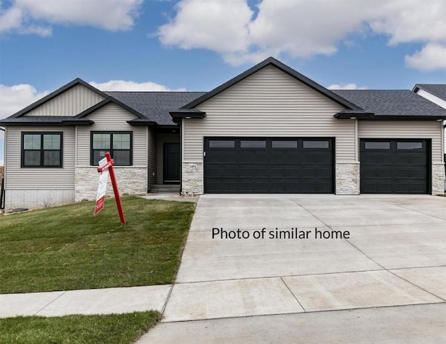 view of front of property with a front yard and a garage