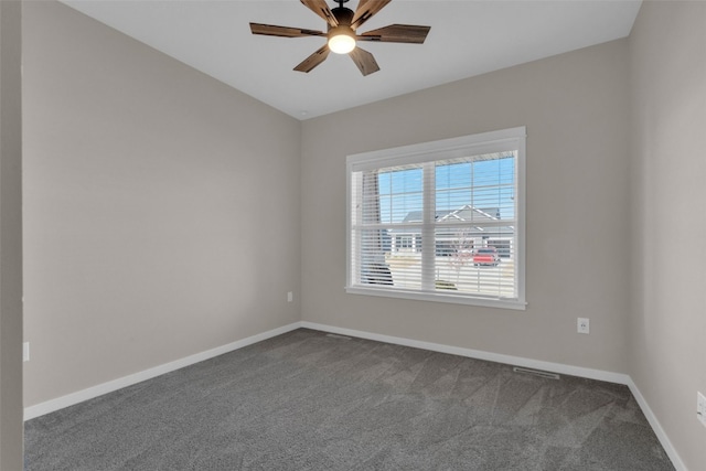 unfurnished room with ceiling fan and carpet