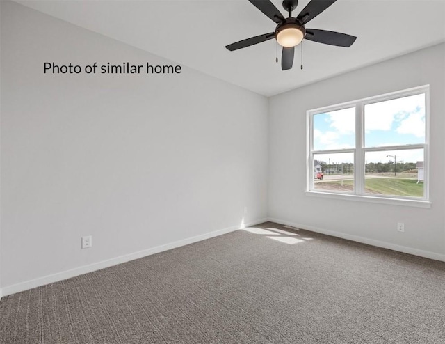 carpeted spare room with ceiling fan