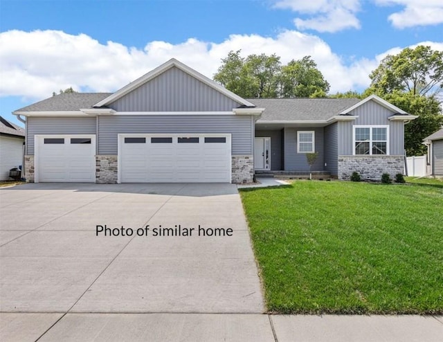 view of front facade with a front yard and a garage