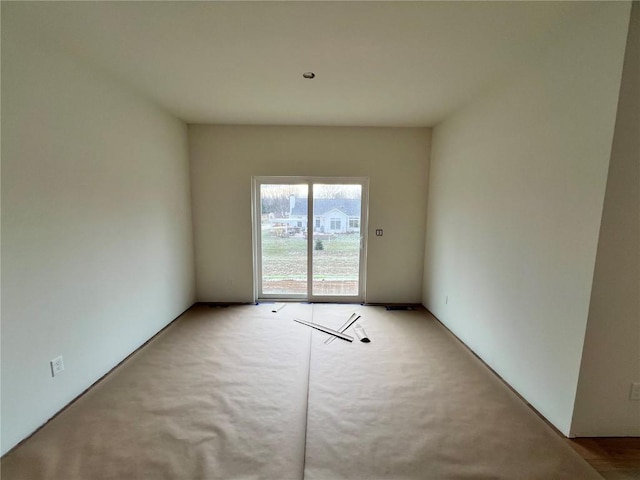 unfurnished room with light colored carpet