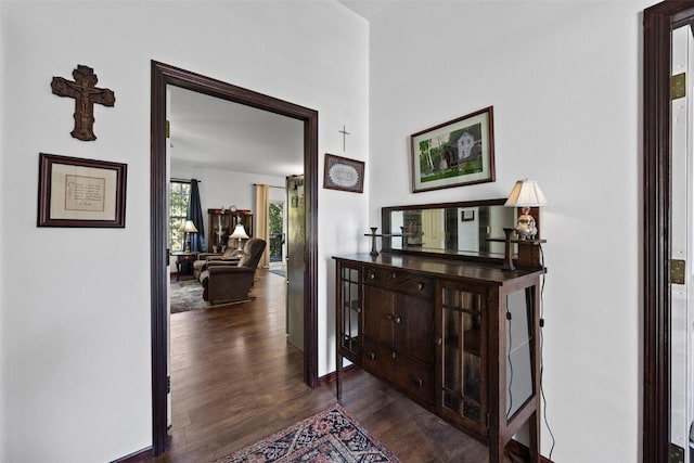 corridor with dark hardwood / wood-style flooring