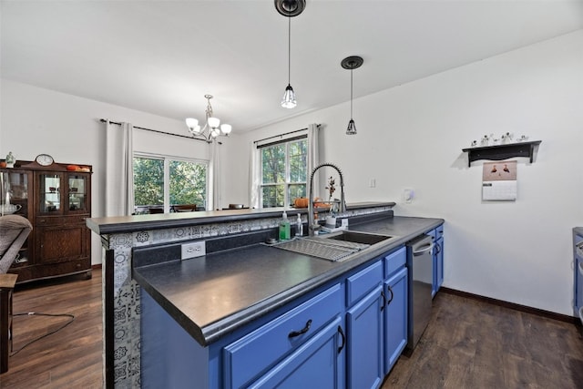 kitchen with dishwasher, dark wood-type flooring, sink, blue cabinets, and a chandelier