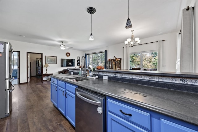 kitchen with a healthy amount of sunlight, stainless steel appliances, dark hardwood / wood-style flooring, and blue cabinets