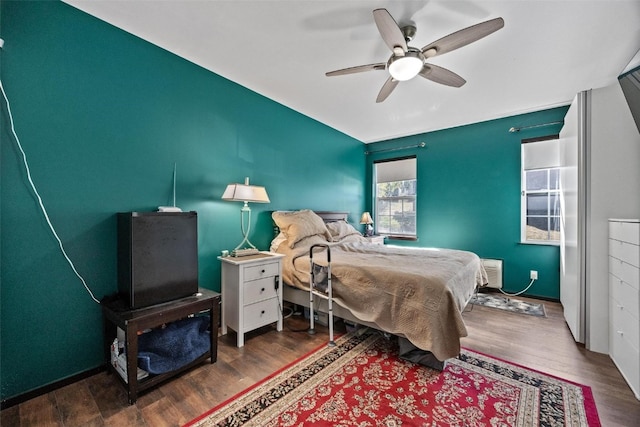 bedroom with dark hardwood / wood-style flooring and ceiling fan