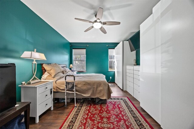 bedroom with dark wood-type flooring and ceiling fan