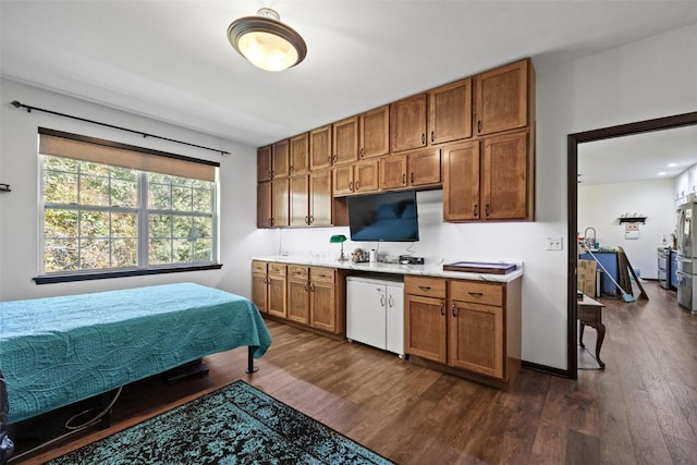 kitchen featuring stainless steel fridge and dark hardwood / wood-style flooring