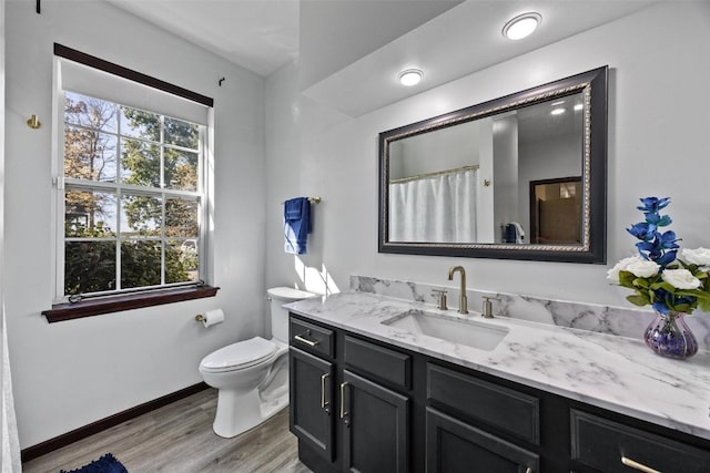 bathroom with vanity, hardwood / wood-style flooring, and toilet