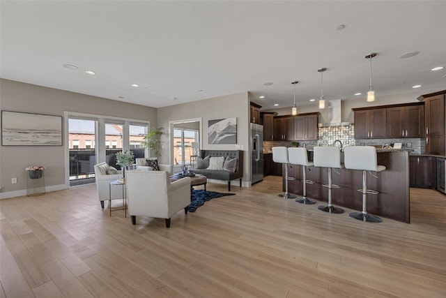 living room featuring light hardwood / wood-style floors and beverage cooler