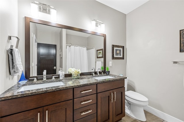 bathroom with vanity, toilet, and tile patterned flooring