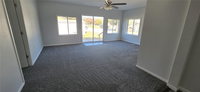 unfurnished room featuring dark carpet and ceiling fan