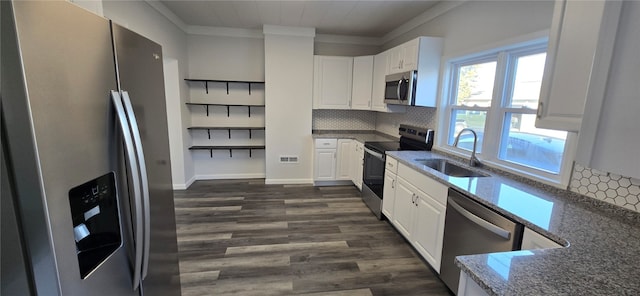 kitchen featuring dark wood-type flooring, stainless steel appliances, dark stone counters, sink, and white cabinetry